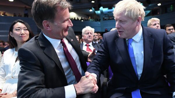 Leadership contender Jeremy Hunt (L) shakes hands to congratulate new Conservative Party leader and incoming prime minister Boris Johnson (R) as the results of the leadership contest are announced at an event in central London on July 23, 2019 - Sputnik International