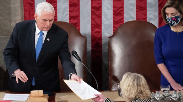 Vice President Mike Pence hands the electoral certificate from the state of Arizona to Rep. Zoe Lofgren, D-Calif., as he presides over a joint session of Congress as it convenes to count the Electoral College votes cast in November's election, at the Capitol in Washington, Jan. 6, 2021. - Sputnik International