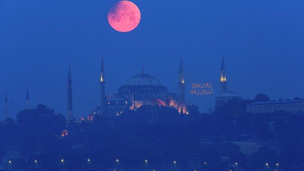 A full moon rises above the iconic Haghia Sophia in Istanbul, Turkey, early Monday, May 16, 2022 - Sputnik International