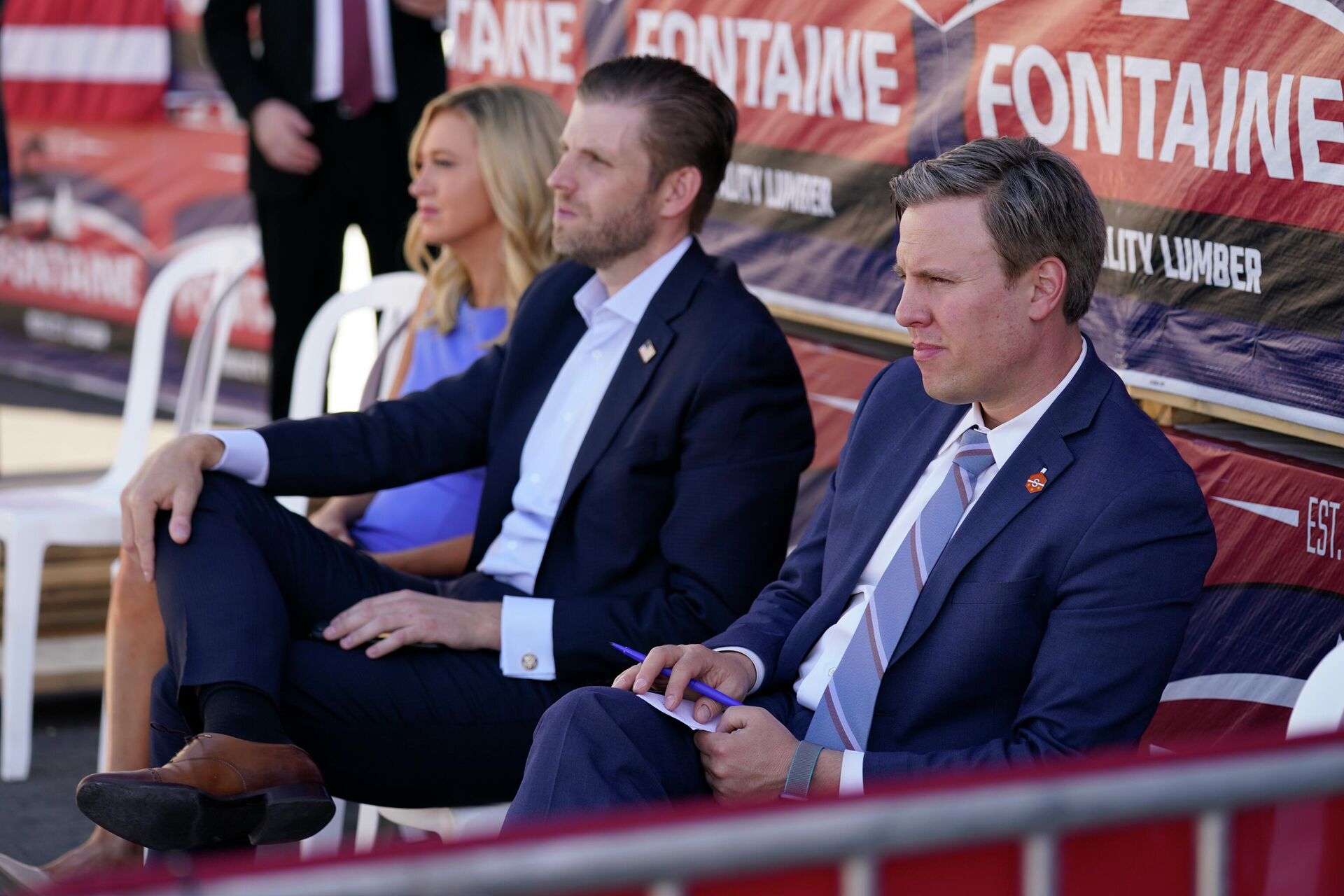 From left, White House press secretary Kayleigh McEnany, Eric Trump, son of President Donald Trump, and campaign manager for Donald Trump's 2020 presidential campaign Bill Stepien, listen as President Donald Trump speaks to a crowd of supporters during a campaign stop at Mariotti Building Product, Thursday, Aug. 20, 2020, in Old Forge, Pa. - Sputnik International, 1920, 13.06.2022