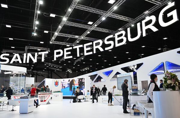Participants stand at the stall of the city of St. Petersburg at the SPIEF in Russia - Sputnik International