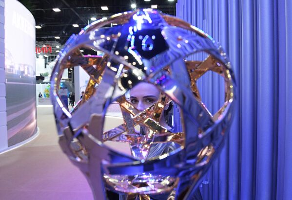 A girl next to the Zenit FC Cup at the Gazprom booth at the XXV St. Petersburg International Economic Forum. - Sputnik International