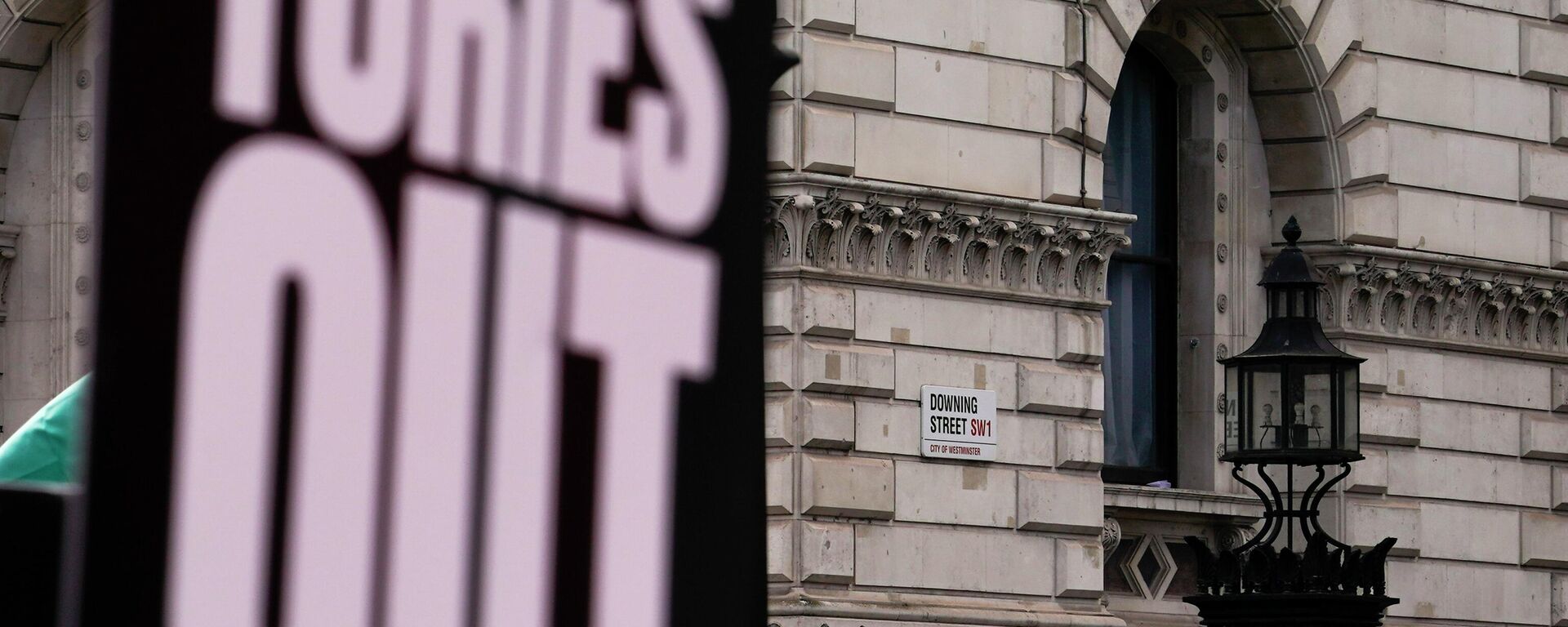 The road sign of Downing Street seen behind a placard reading 'Tories out', during a protest against the increase of the cost of living, in London, Saturday, April 2, 2022. - Sputnik International, 1920, 21.06.2022