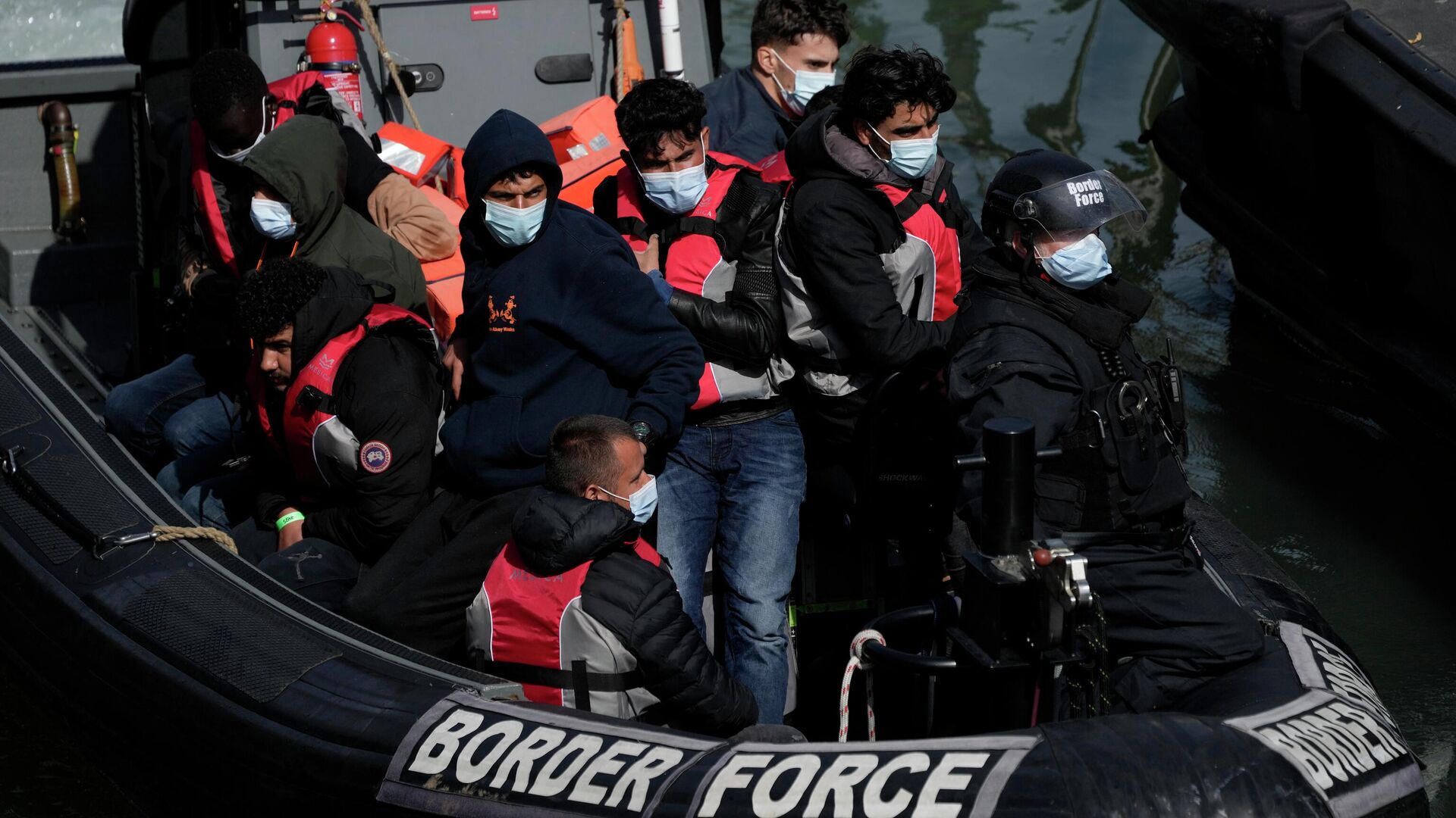 People thought to be migrants who undertook the crossing from France in small boats and were picked up in the Channel, arrive to be disembarked from a small transfer boat which ferried them from a larger British border force vessel that didn't come into the port, in Dover, south east England, Friday, June 17, 2022 - Sputnik International, 1920, 22.06.2022