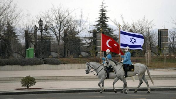 A handout picture obtained from the Israeli Government Press Office (GPO) on March 9, 2022, shows Turkish cavalry guards waving the Israeli (R) and Turkish flags, to welcome the Israeli president in the capital Ankara. - Israel's president Isaac Herzog landed in Ankara today on a trip aimed at repairing fractured ties with Turkey, in the first visit to the country by an Israeli head of state since 2007. (Photo by GPO / AFP) / RESTRICTED TO EDITORIAL USE - MANDATORY CREDIT AFP PHOTO /  GPO   - Sputnik International