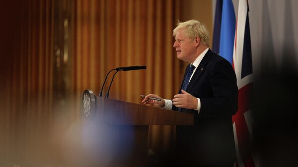 Britain's Prime Minister Boris Johnson gestures as he addresses a press conference during the Commonwealth Heads of Government Meeting (CHOGM) at Lemigo Hotel in Kigali on June 24, 2022. - Sputnik International