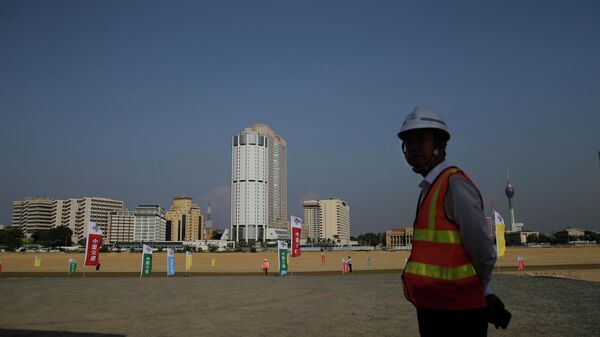  In this Jan. 2, 2018, file photo, a Chinese construction worker stands on land that was reclaimed from the Indian Ocean for the Colombo Port City project, initiated as part of China's ambitious One Belt One Road initiative, in Colombo, Sri Lanka. - Sputnik International