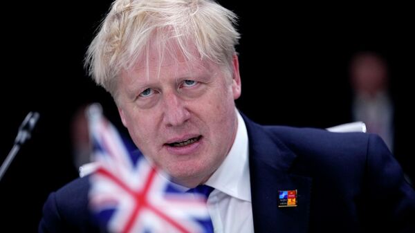 British Prime Minister Boris Johnson waits for the start of a round table meeting at a NATO summit in Madrid, Spain on Wednesday, June 29, 2022 - Sputnik International