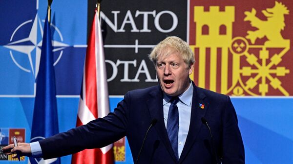Britain's Prime Minister Boris Johnson gestures as he addresses media representatives during a press conference at the NATO summit at the Ifema congress centre in Madrid, on June 30, 2022. - Sputnik International