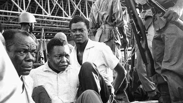 Congo's former prime minister Patrice Lumumba, center right, with hands tied behind his back, sits in a truck upon arrival at Leopoldville (now Kinshasa) Airport in Congo, Dec. 2, 1960, following his arrest the previous day. On Monday, more than sixty one years after his death, the mortal remains of Congo's first democratically elected prime minister Patrice Lumumba will be handed over to his children during an official ceremony in Belgium. - Sputnik International