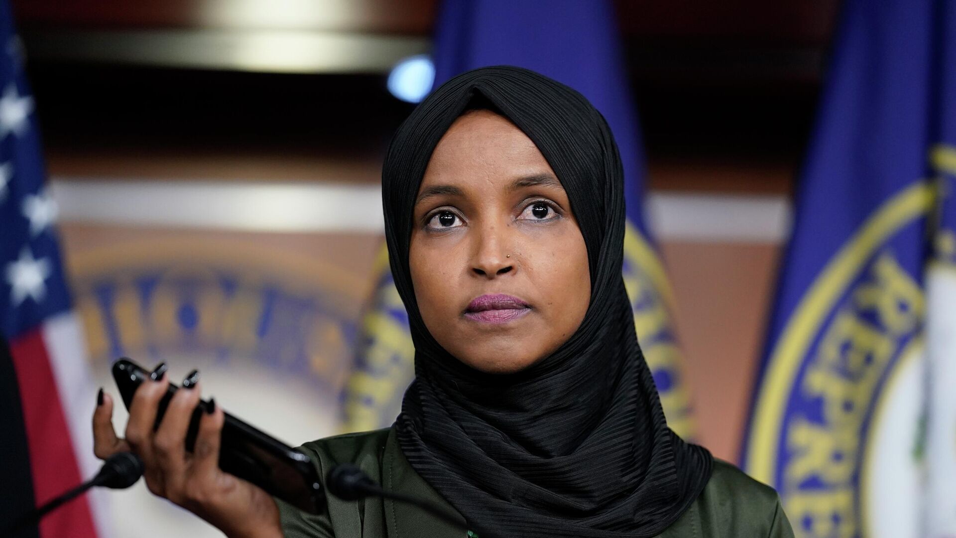 Rep. Ilhan Omar, D-Minn., plays a recording of a death threat left on her voicemail in the wake of anti-Islamic comments made last week by Rep. Lauren Boebert, R-Colo., who likened Omar to a bomb-carrying terrorist, during a news conference at the Capitol in Washington, Tuesday, Nov. 30, 2021 - Sputnik International, 1920, 02.07.2022