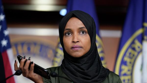 Rep. Ilhan Omar, D-Minn., plays a recording of a death threat left on her voicemail in the wake of anti-Islamic comments made last week by Rep. Lauren Boebert, R-Colo., who likened Omar to a bomb-carrying terrorist, during a news conference at the Capitol in Washington, Tuesday, Nov. 30, 2021 - Sputnik International