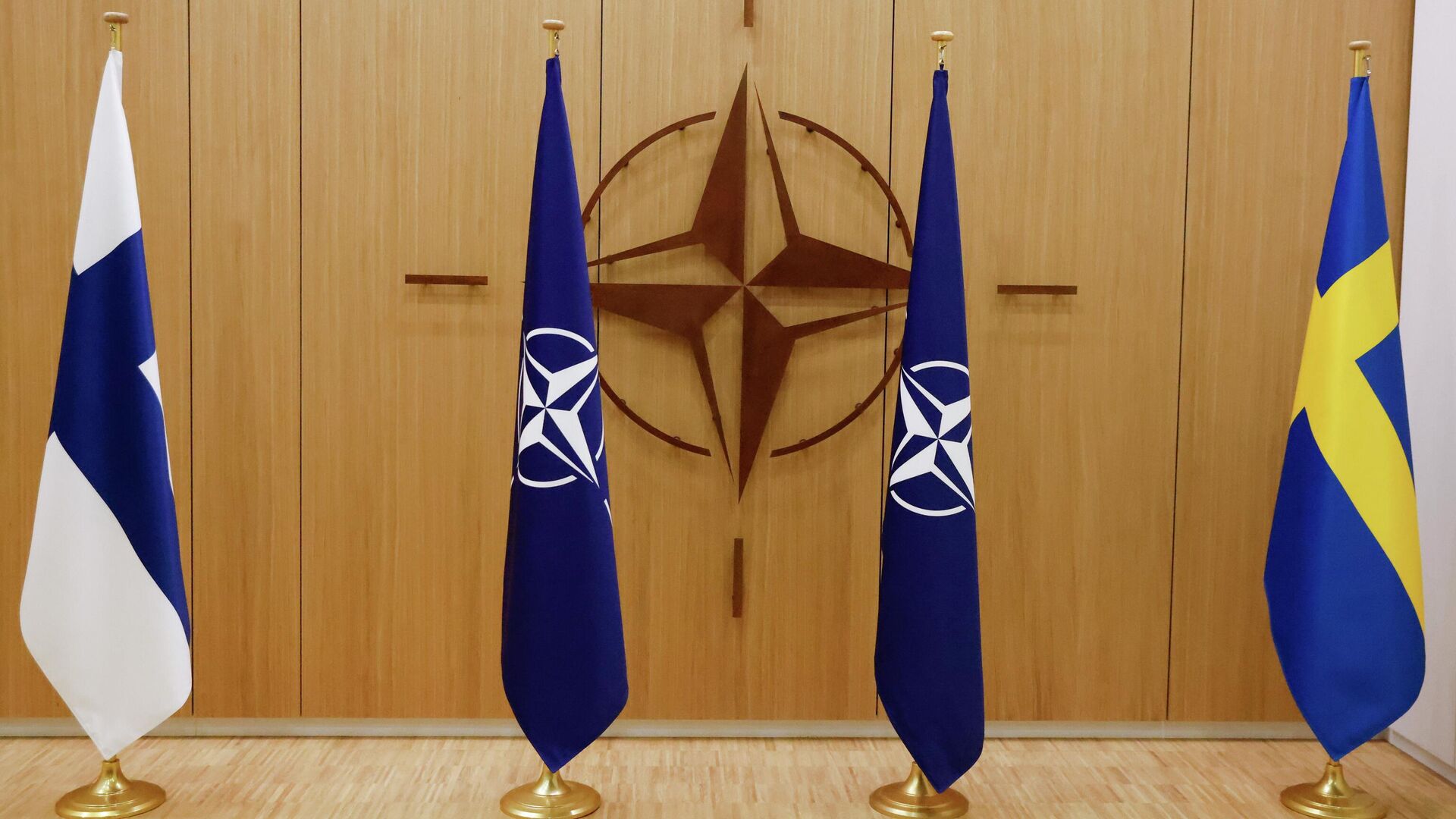 Flags of Finland, left, NATO and Sweden, right, are displayed during a ceremony to mark Sweden's and Finland's application for membership in Brussels, Belgium, Wednesday May 18, 2022. NATO Secretary-General Jens Stoltenberg said that the military alliance stands ready to seize a historic moment and move quickly on allowing Finland and Sweden to join its ranks, after the two countries submitted their membership requests. (Johanna Geron/Pool via AP) - Sputnik International, 1920, 13.07.2022