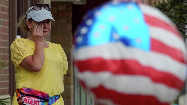 Женщина вытирает слезы после массовой стрельбы на параде Четвертого июля в Хайленд-Парке, штат Иллинойс, США - Sputnik International