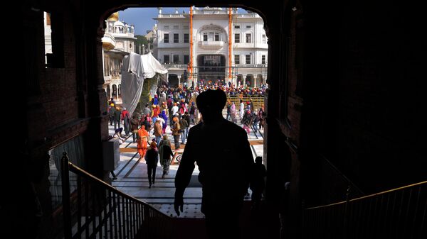 A Sikh walks out after praying in Golden temple in Amritsar, in Indian state of Punjab, Thursday, Feb. 17, 2022. India's Punjab state will cast ballots on Sunday, in polls that are seen as a barometer of Prime Minister Narendra Modi's popularity ahead of general elections in 2024 and his party's Hindu nationalist reach. - Sputnik International