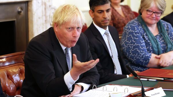 Britain's Prime Minister Boris Johnson, left, and Britain's Chancellor of the Exchequer Rishi Sunak, center, take part in a cabinet meeting, in Downing Street, London, Tuesday, July 5, 2022 - Sputnik International