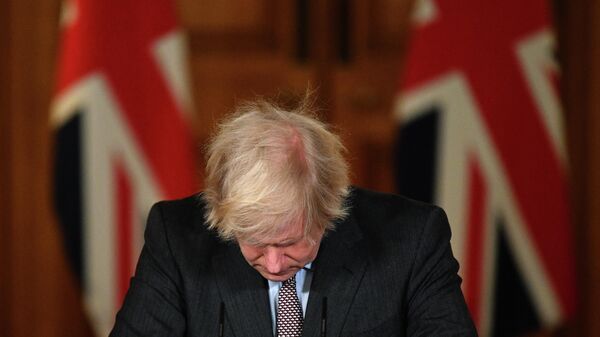 (FILES) In this file photo taken on January 26, 2021 Britain's Prime Minister Boris Johnson looks down at the podium as he attends a virtual press conference inside 10 Downing Street in central London. - Boris Johnson will resign as Conservative party leader on July 7, 2022 - Sputnik International