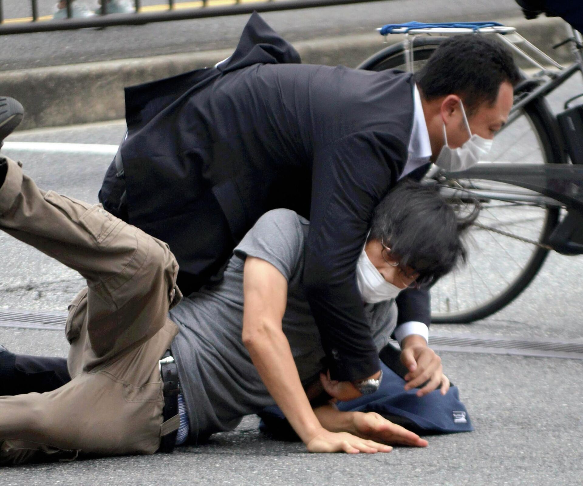 Tetsuya Yamagami, bottom, is detained near the site of gunshots in Nara Prefecture, western Japan, Friday, July 8, 2022 - Sputnik International, 1920, 11.07.2022