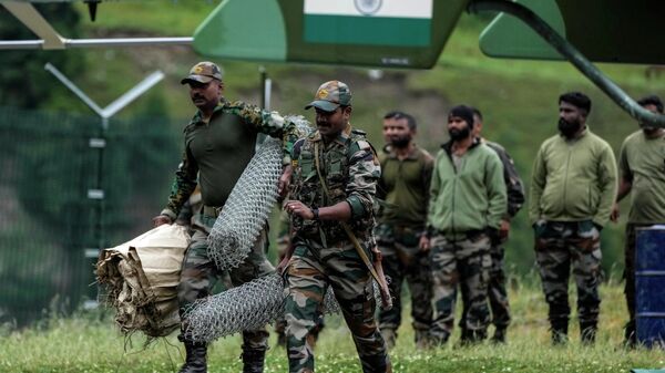 Indian army soldiers leave for a rescue mission from Baltal, 105 kilometers (65miles) northeast of Srinagar, Indian controlled Kashmir, Saturday, July 9, 2022. More than ten pilgrims have been killed and many feared missing after a cloudburst triggered a flash flooding during an annual Hindu pilgrimage to an icy Himalayan cave in Indian-controlled Kashmir. Officials say the cloudburst near the hollowed mountain cave revered by Hindus on Friday sent a wall of water down a mountain gorge and swept about two dozen encampments and two makeshift kitchens. - Sputnik International