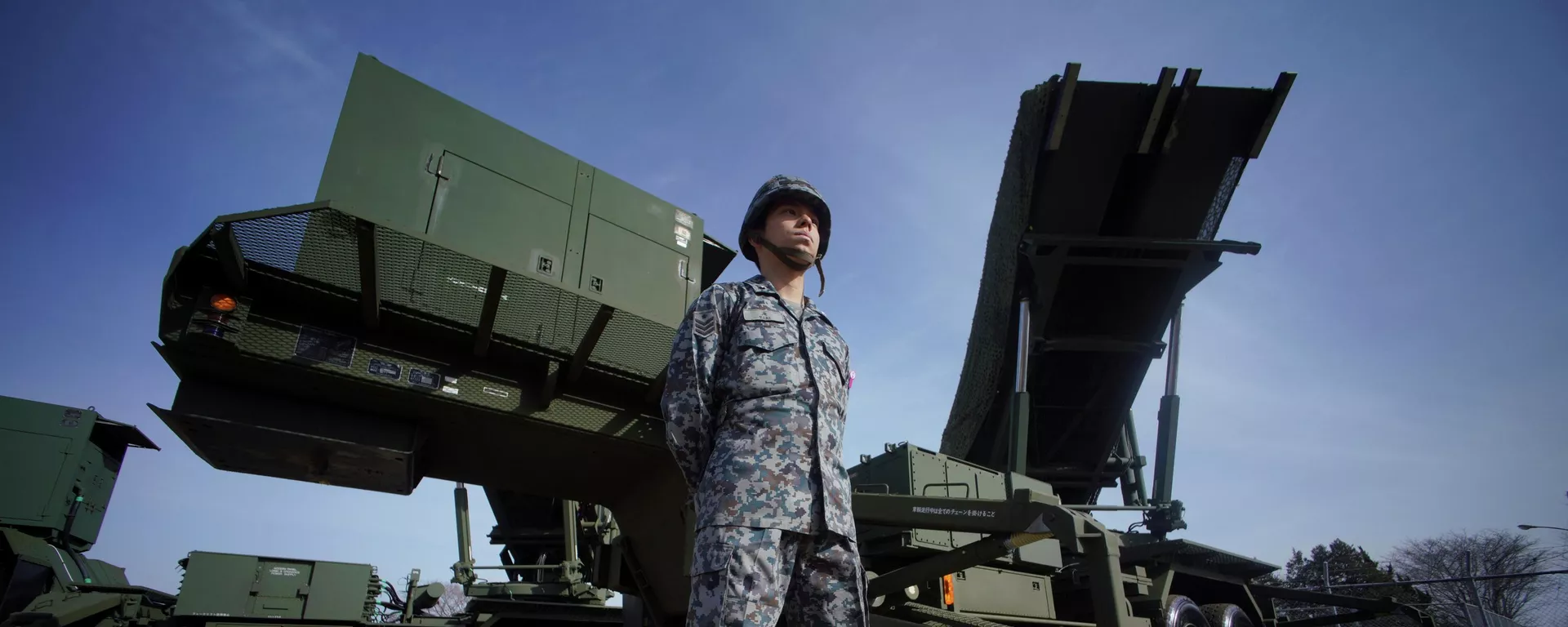 In this Jan. 18, 2018, file photo, a member of the Japan Ground Self-Defense Force stands guard next to a surface-to-air Patriot Advanced Capability-3 (PAC-3) missile interceptor launcher vehicle at Narashino Exercise Area in Funabashi, east of Tokyo.  - Sputnik International, 1920, 25.12.2024