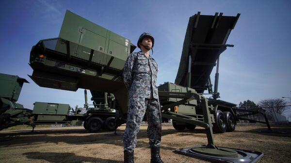 In this Jan. 18, 2018, file photo, a member of the Japan Ground Self-Defense Force stands guard next to a surface-to-air Patriot Advanced Capability-3 (PAC-3) missile interceptor launcher vehicle at Narashino Exercise Area in Funabashi, east of Tokyo.  - Sputnik International