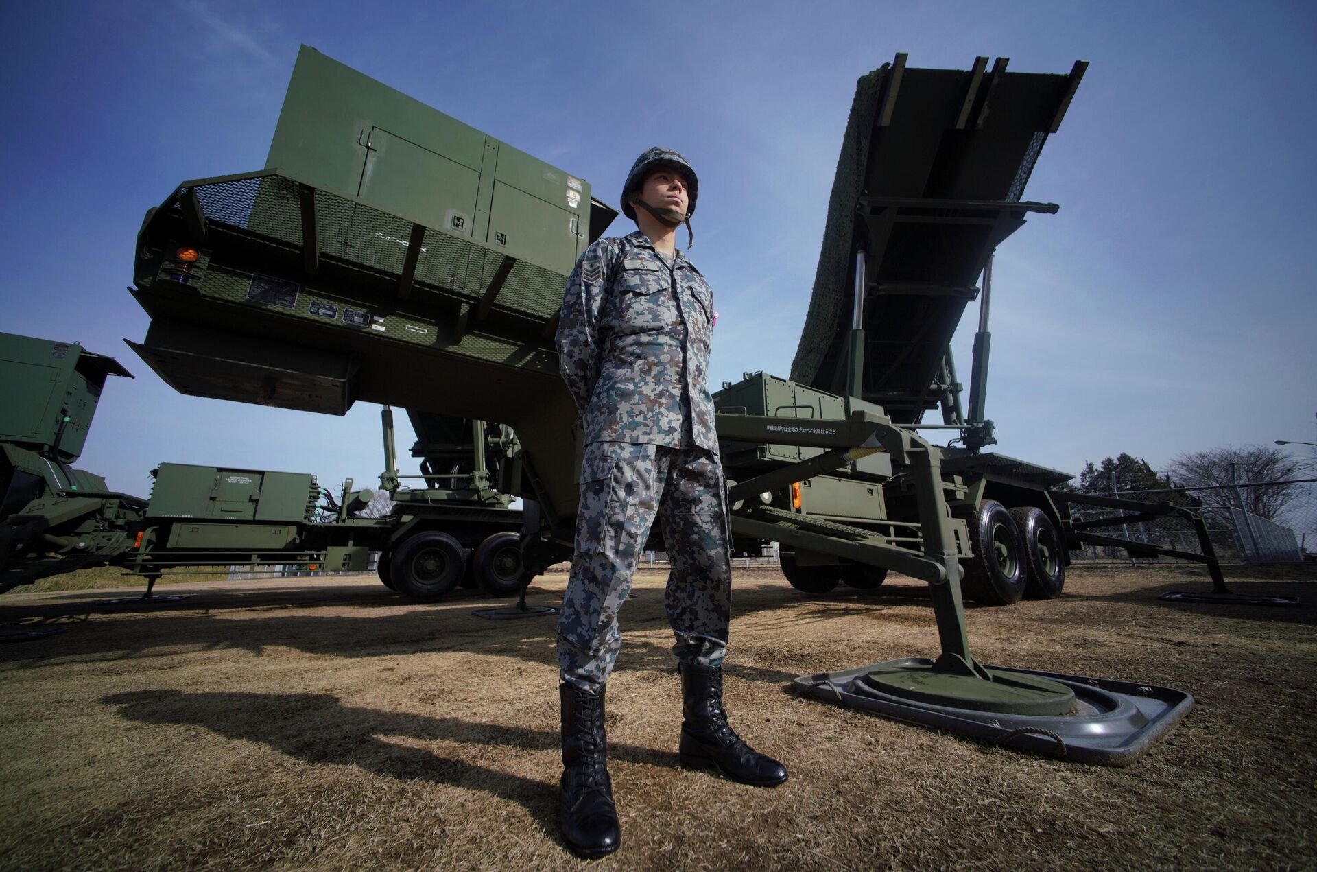 In this Jan. 18, 2018, file photo, a member of the Japan Ground Self-Defense Force stands guard next to a surface-to-air Patriot Advanced Capability-3 (PAC-3) missile interceptor launcher vehicle at Narashino Exercise Area in Funabashi, east of Tokyo.  - Sputnik International, 1920, 06.11.2022