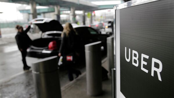 FILE -  In this March 15, 2017, file photo, a sign marks a pick-up point for the Uber car service at LaGuardia Airport in New York - Sputnik International