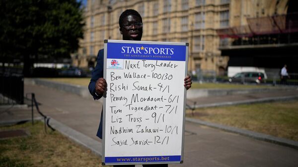 A political betting analyst for Star Sports bookmakers poses with a board showing odds on the next leader of the ruling British Conservative Party and British Prime Minister - Sputnik International