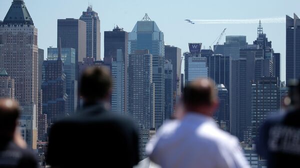 People watch as a formation of the Blue Angels and Thunderbirds flight teams pass in front of the New York City skyline as seen from Weehawken, N.J., Tuesday, April 28, 2020. The flyover was in salute to the medical personnel, first responders and other essential workers in the fight against the new coronavirus.  - Sputnik International