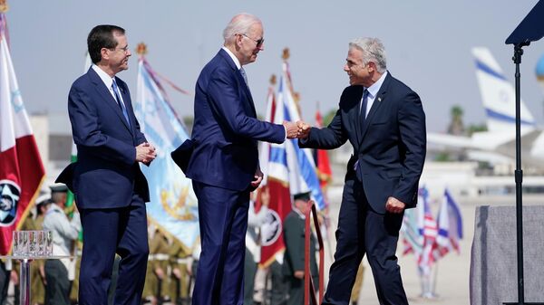 President Joe Biden is greeted by Israeli Prime Minister Yair Lapid, right and President Isaac Herzog, left, as they participate in an arrival ceremony after Biden arrived at Ben Gurion Airport, Wednesday, July 13, 2022, in Tel Aviv.  - Sputnik International