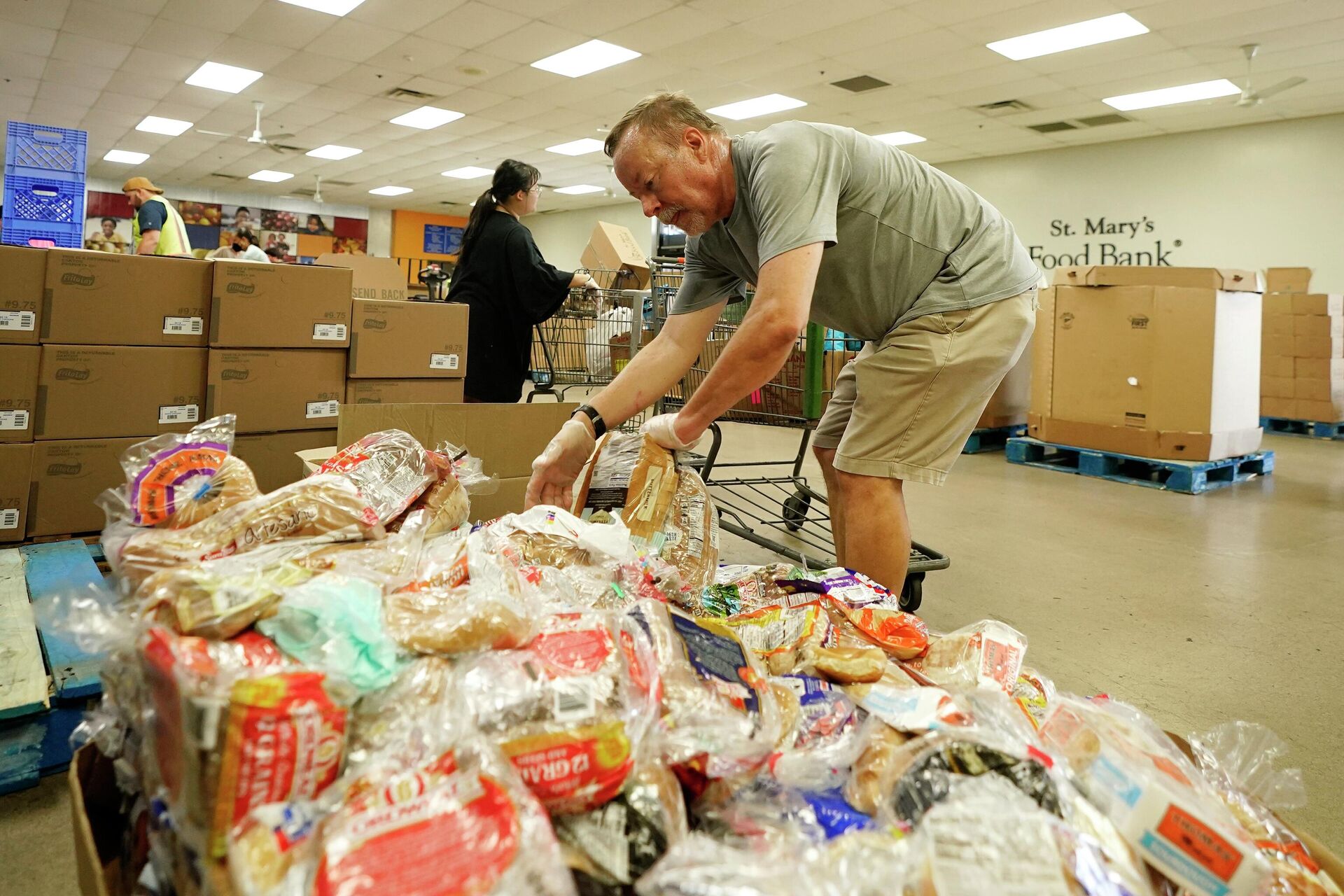 Volunteers fill up grocery carts with food for distribution into drive through vehicles at the St. Mary's Food Bank Wednesday, June 29, 2022, in Phoenix - Sputnik International, 1920, 21.10.2022
