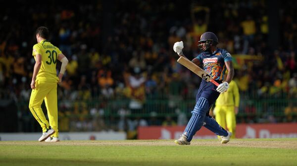 Sri Lanka's Chamika Karunaratne, right, celebrates scoring a half century during the fifth one-day international cricket match between Australia and Sri Lanka in Colombo, Sri Lanka, Friday, June 24, 2022. - Sputnik International