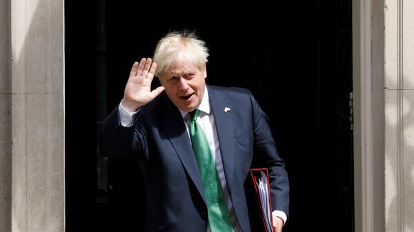 Britain's Prime Minister Boris Johnson walks to a waiting car as he leaves from 10 Downing Street in central London on July 13, 2022 to head to the Houses of Parliament for the weekly Prime Minister's Questions (PMQs) session - Sputnik International