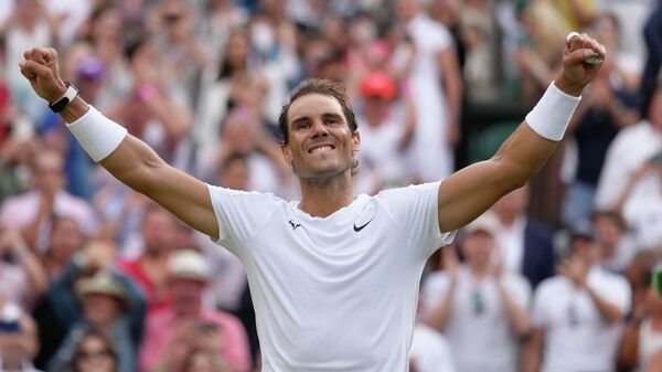 Spain's Rafael Nadal celebrates after beating Taylor Fritz of the US in a men's singles quarterfinal match on day ten of the Wimbledon tennis championships in London, Wednesday, July 6, 2022 - Sputnik International