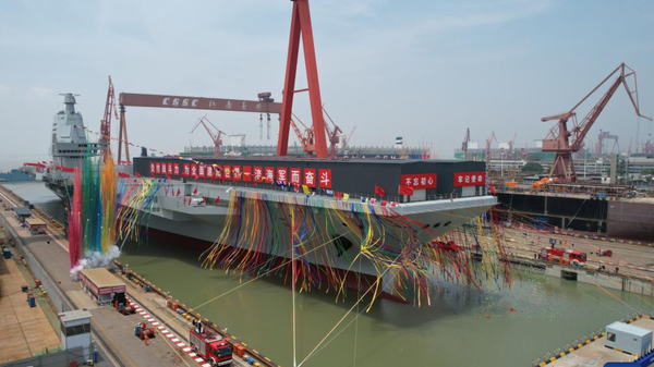Photo taken on June 17, 2022 shows the launching ceremony of China's third aircraft carrier, the Fujian, in east China's Shanghai. The carrier, named after Fujian Province, was completely designed and built by the country. - Sputnik International