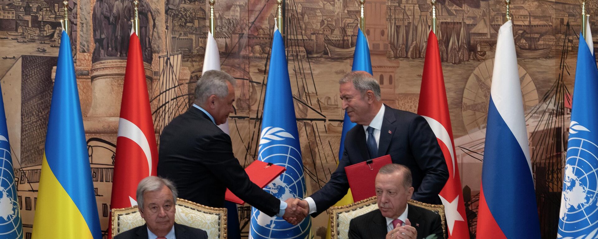 Turkish President Recep Tayyip Erdogan, right, and U.N. Secretary General, Antonio Guterres, sit as two representatives of Ukraine and Russia delegations check hands during a signing ceremony at Dolmabahce Palace in Istanbul, Turkey, Friday, July 22, 2022 - Sputnik International, 1920, 22.07.2022