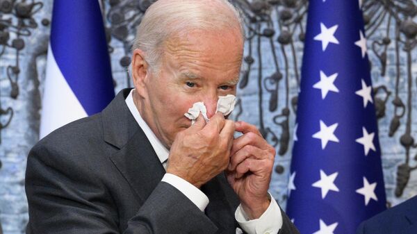 In this file photo taken on July 14, 2022, US President Joe Biden wipes his nose after signing the guest book while visiting Israel's President Isaac Herzog at Beit HaNassi, the presidential residence in Jerusalem - Sputnik International