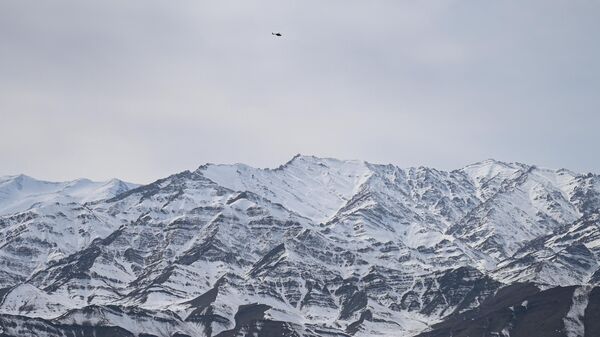 Indian army’s helicopter flies over snow covered mountains near Leh, the joint capital of the union territory of Ladakh on February 28, 2022. - Sputnik International