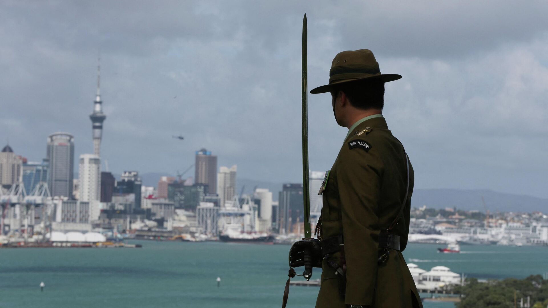 A member of the New Zealand Army looks on as navy ships arrive into the Waitemata Harbour as part of the fleet entry to celebrate the Royal New Zealand Navy's 75th anniversary in Auckland on November 16, 2016 - Sputnik International, 1920, 01.08.2022