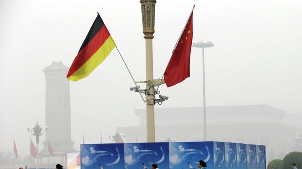 German and Chinese national flags are attached to a lamp post on Tiananmen Square to mark the visit of German Chancellor Angela Merkel outside the Great Hall of the People in Beijing on hazy Thursday, Aug. 30, 2012. (AP Photo/Ng Han Guan) - Sputnik International