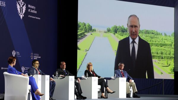 Russian President Vladimir Putin is seen on a screen as he delivers a video address to participants of the 10th St. Petersburg International Legal Forum (SPILF) in St. Petersburg, Russia - Sputnik International