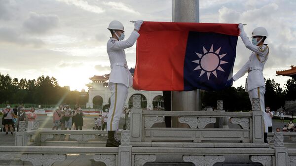  Two soldiers fold a flag during the daily flag ceremony on the Liberty Square of Chiang Kai-shek Memorial Hall in Taipei, Taiwan, Saturday, July 30, 2022 - Sputnik International