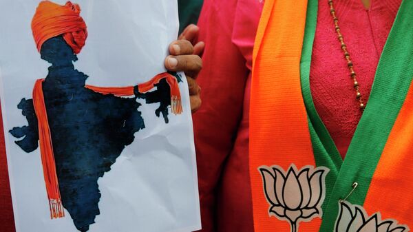 FILE- In this Monday, Aug. 5, 2019 file photo, a participant displays an artist's impression of the India map decorated with a saffron shawl as ruling Bharatiya Janata Party (BJP) supporters celebrate government revoking disputed Kashmir's special status in Prayagraj, India - Sputnik International