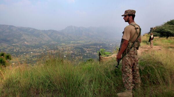In this Oct. 1, 2016, file photo, Pakistan army soldiers monitor the area from the hilltop Bagsar post on the line of control, that divides Kashmir between Pakistan and India, near Bhimber, some 166 kilometers (103 miles) from Islamabad, Pakistan. - Sputnik International