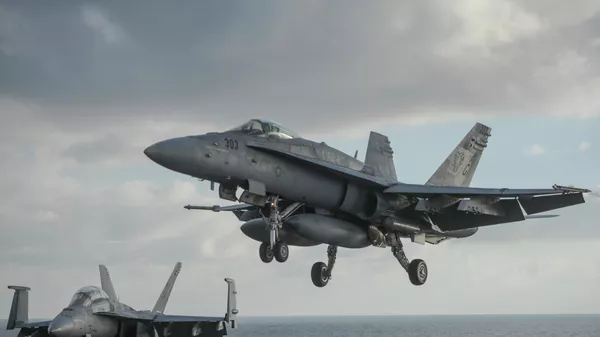 A F/A-18 Hornet lands aboard the nuclear-powered aircraft carrier USS Harry S. Truman, during a visit by Ukraine's Prime Minister Arseniy Yatsenyuk, at an undisclosed position in the Mediterranean Sea, south of Sicily, Thursday, Dec.3, 2015.  - Sputnik International