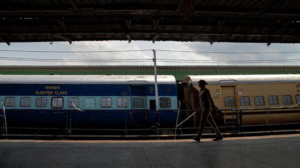An Indian security person patrols a deserted railway platform during a nationwide lockdown to curb the spread of new coronavirus in Gauhati, India, Sunday, April 19, 2020. - Sputnik International
