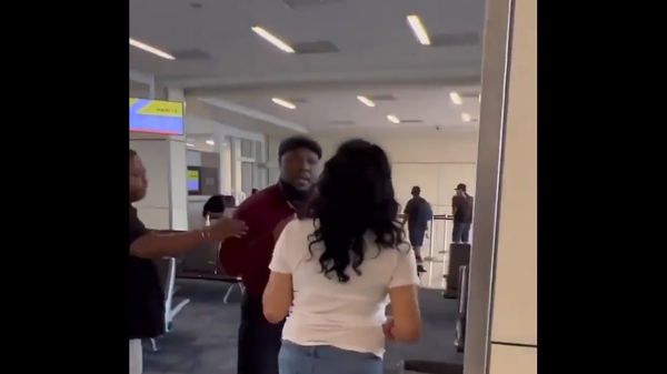 A screenshot from the video showing altercation between Spirit Airlines employee and a passenger, August 11, 2022. - Sputnik International
