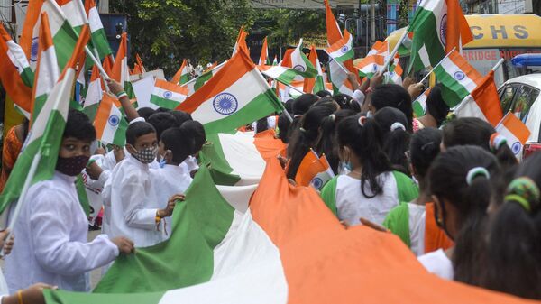 Students carry Indian national flags during a parade, ahead of country's 75th Independence Day celebrations in Hyderabad on August 13, 2022.  - Sputnik International