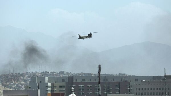 A U.S. Chinook helicopter flies over the city of Kabul, Afghanistan, Sunday, Aug. 15, 2021. Taliban fighters entered the outskirts of the Afghan capital on Sunday, further tightening their grip on the country as panicked workers fled government offices and helicopters landed at the U.S. Embassy. - Sputnik International