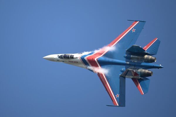 A member of the "Russian Knights" (Russikiye Vityazi) Russian Air Force aerobatic display team flying Sukhoi SU-35S and Su-30SM fighters, at the opening ceremony of the International Military-Technical Forum ARMY-2022 in Kubinka. - Sputnik International